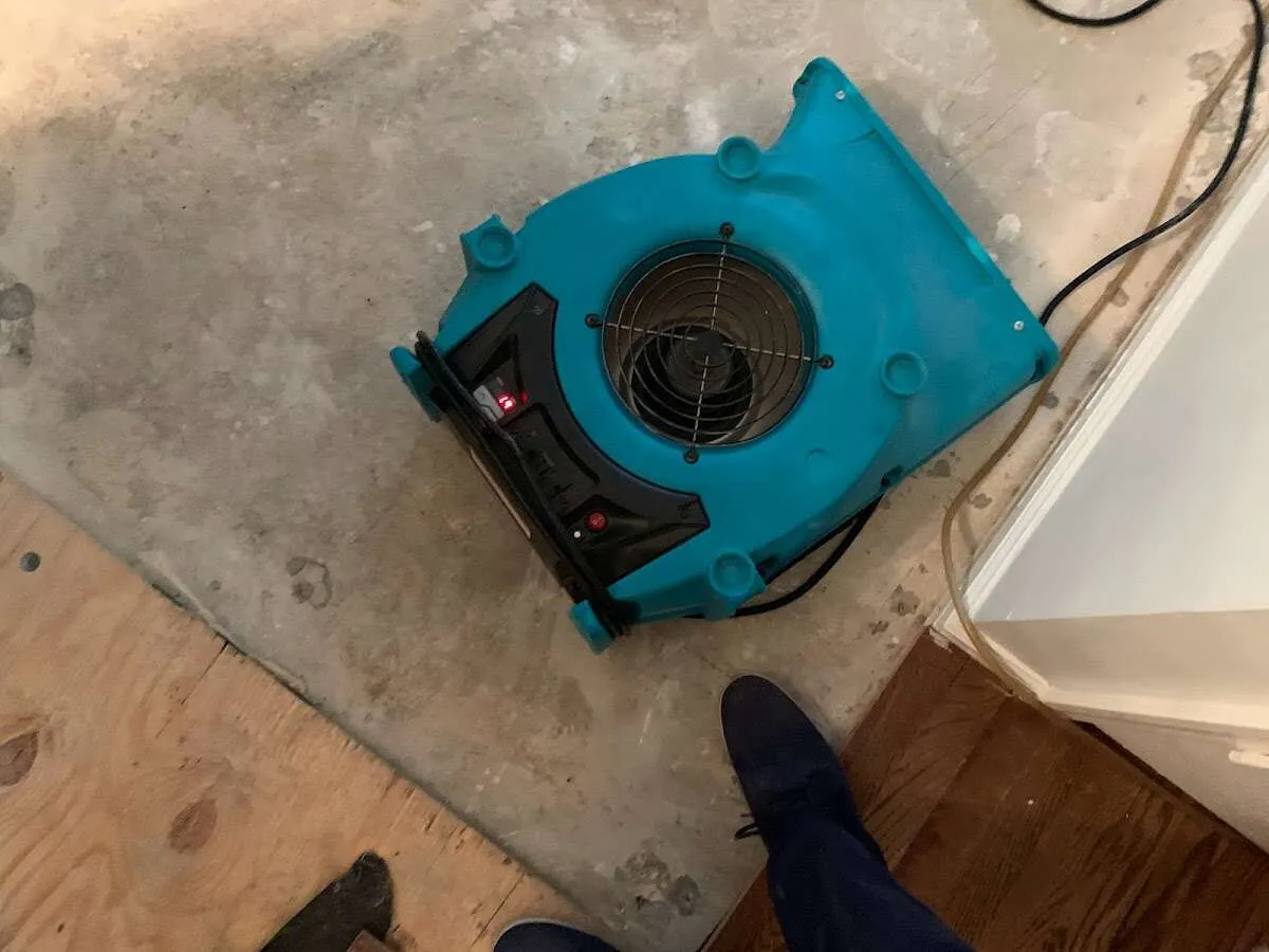 Air mover drying subfloor during Commercial Water Damage Restoration in Westtown